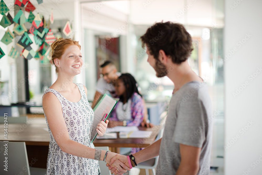 People shaking hands in office People shaking hands in office