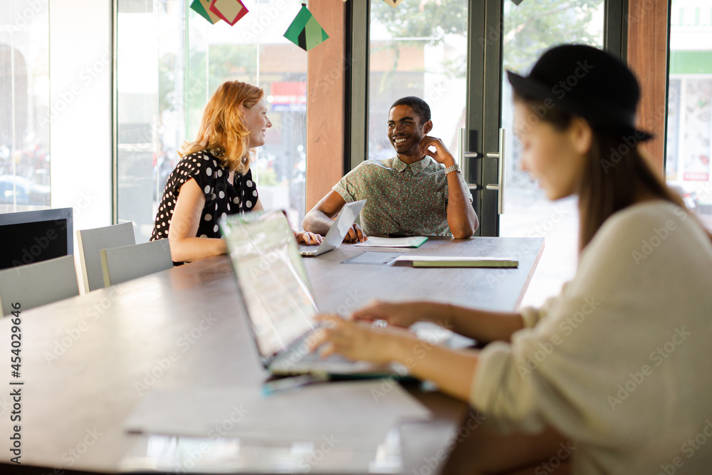 People working at conference table in office People working at conference table in office