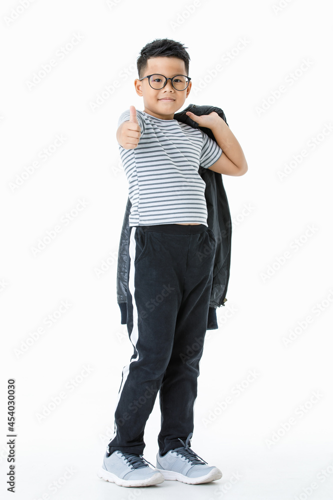 Lovely cutout portrait of smart Asian healthy boy wearing glasses and casual horizontal striped shirt and long pants holding jacket and confidently thumb up as satisfying and trust great thing Lovely cutout portrait of smart Asian healthy boy wearing glasses and casual horizontal striped shirt and long pants holding jacket and confidently thumb up as satisfying and trust great thing