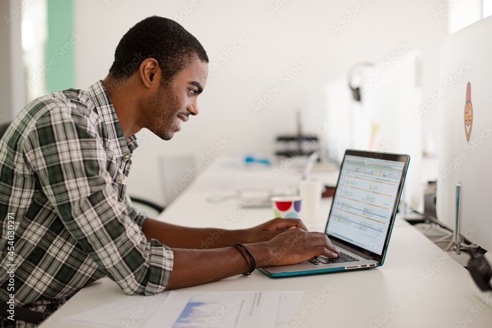 Man working on laptop at office Man working on laptop at office