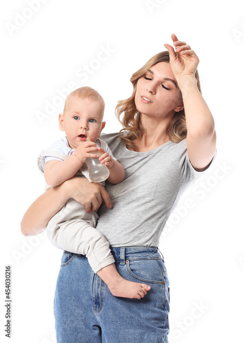 Tired young mother giving w...