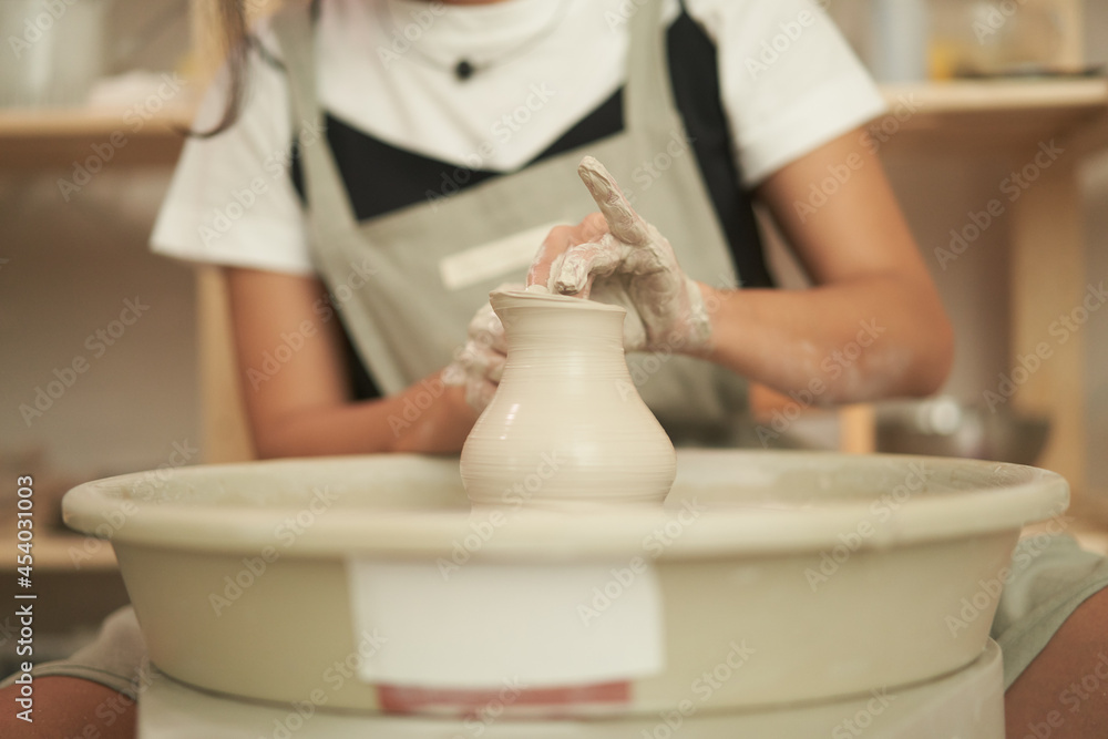 Artisan making clay vessel in studio Artisan making clay vessel in studio