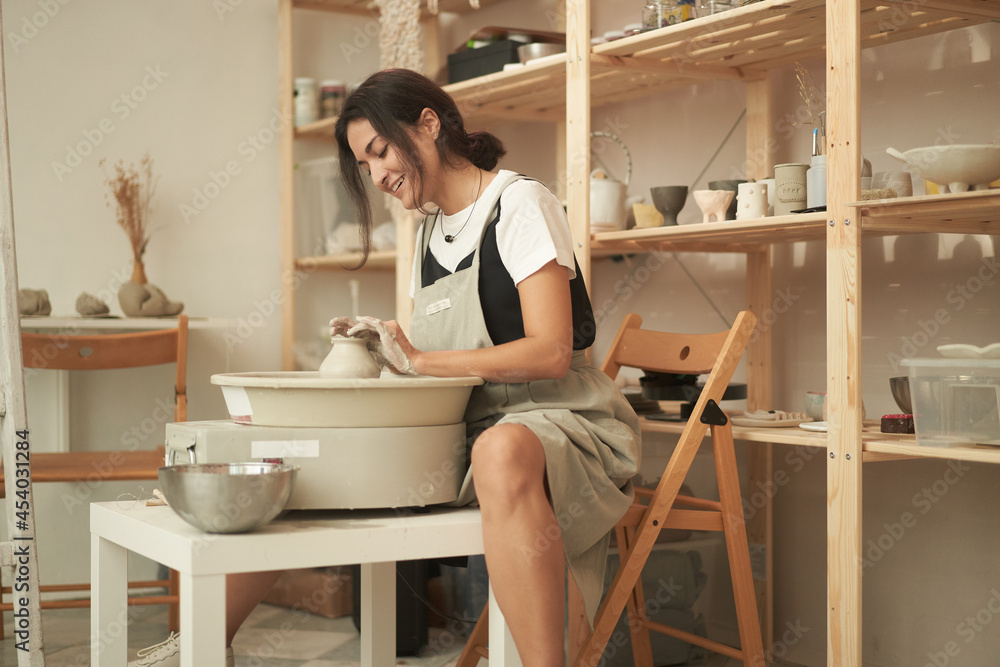Woman crafting handmade crockery in workshop Woman crafting handmade crockery in workshop