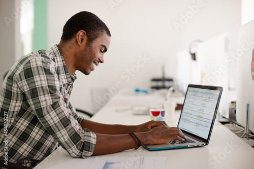 Man working on laptop at office