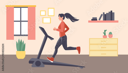 A woman is exercising on a treadmill at home. Fitness at home. The concept of a healthy lifestyle at home.
