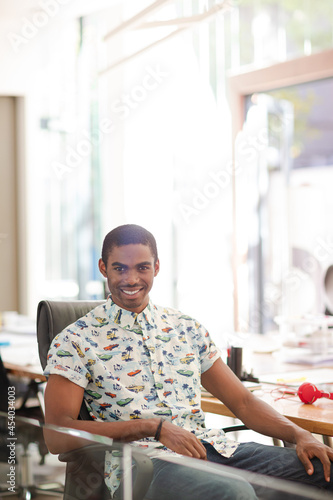 Man smiling at desk in office