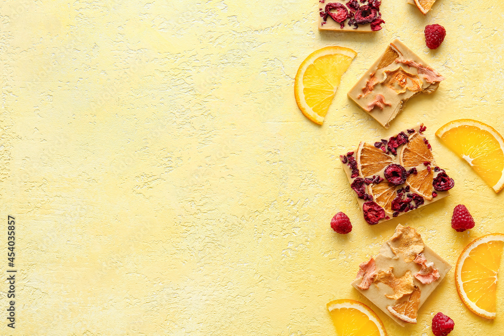 Handmade chocolate bars with fruits and berries on color background Handmade chocolate bars with fruits and berries on color background