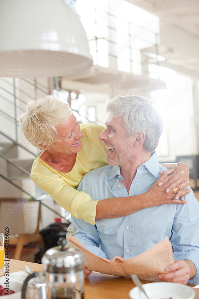 Older couple hugging with coffee cup Older couple hugging with coffee cup