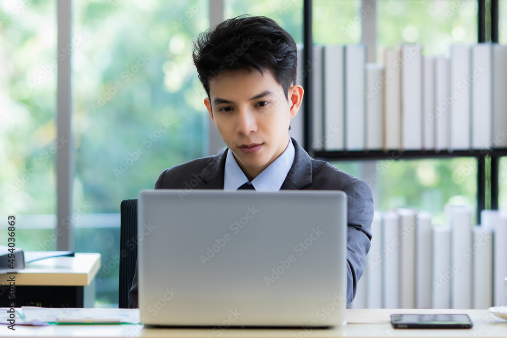Confused ethnic male entrepreneur working on laptop in office Confused ethnic male entrepreneur working on laptop in office