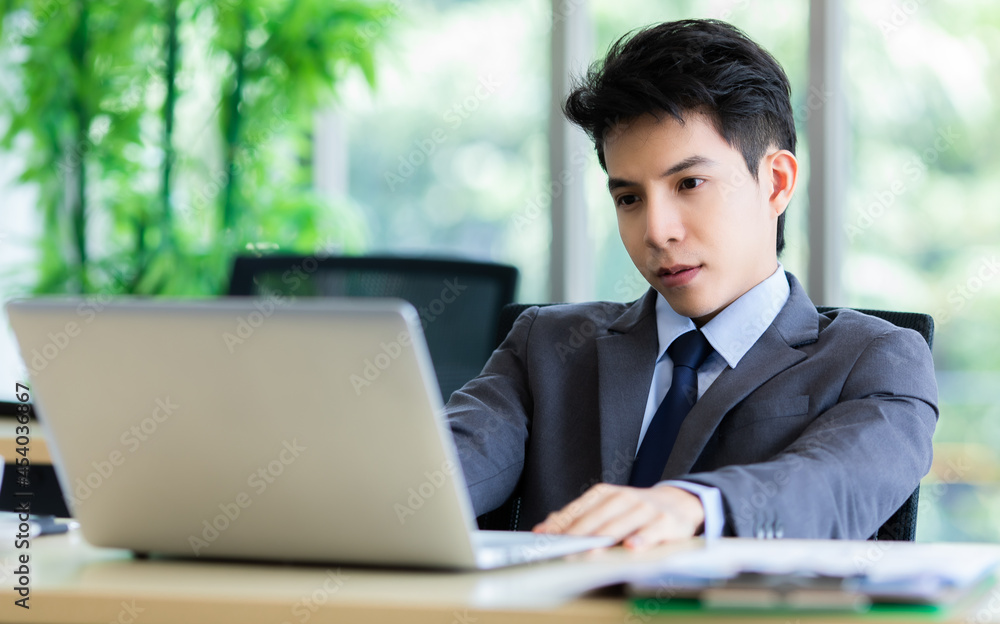 Confused ethnic male entrepreneur working on laptop in office Confused ethnic male entrepreneur working on laptop in office
