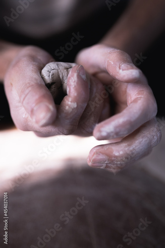 Close up of hands working with clay