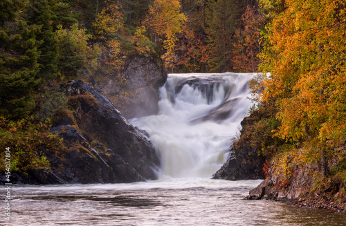Beautiful waterfall in the autumn forest, Oulanka national park, Finland photo