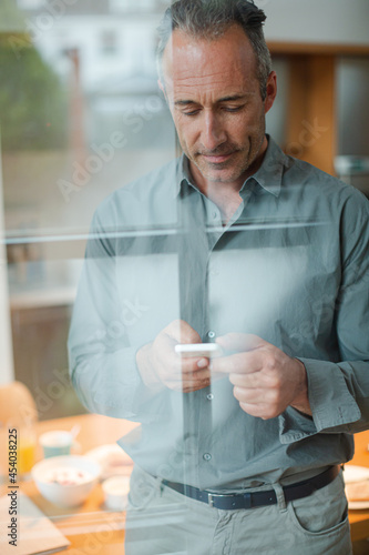 Older man texting on cell phone