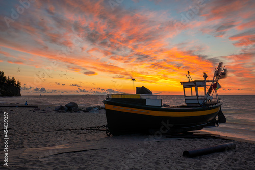 Fishing boats on the sea beach during the spectacular sunrise
