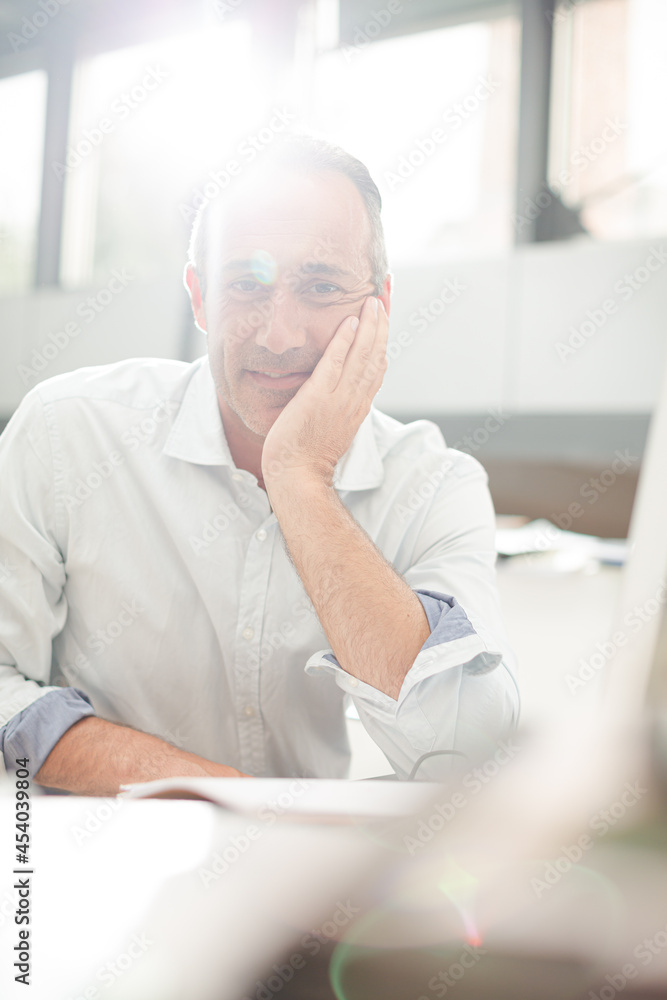 Businessman reading paperwork at home office desk Businessman reading paperwork at home office desk