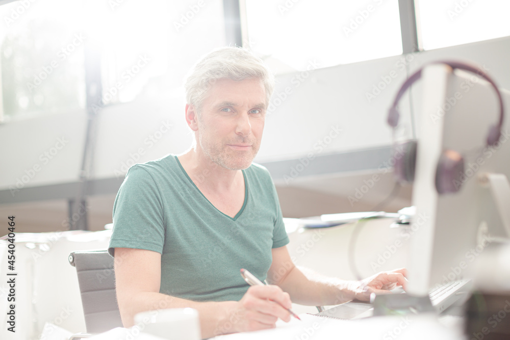 Smiling older man sitting at desk Smiling older man sitting at desk