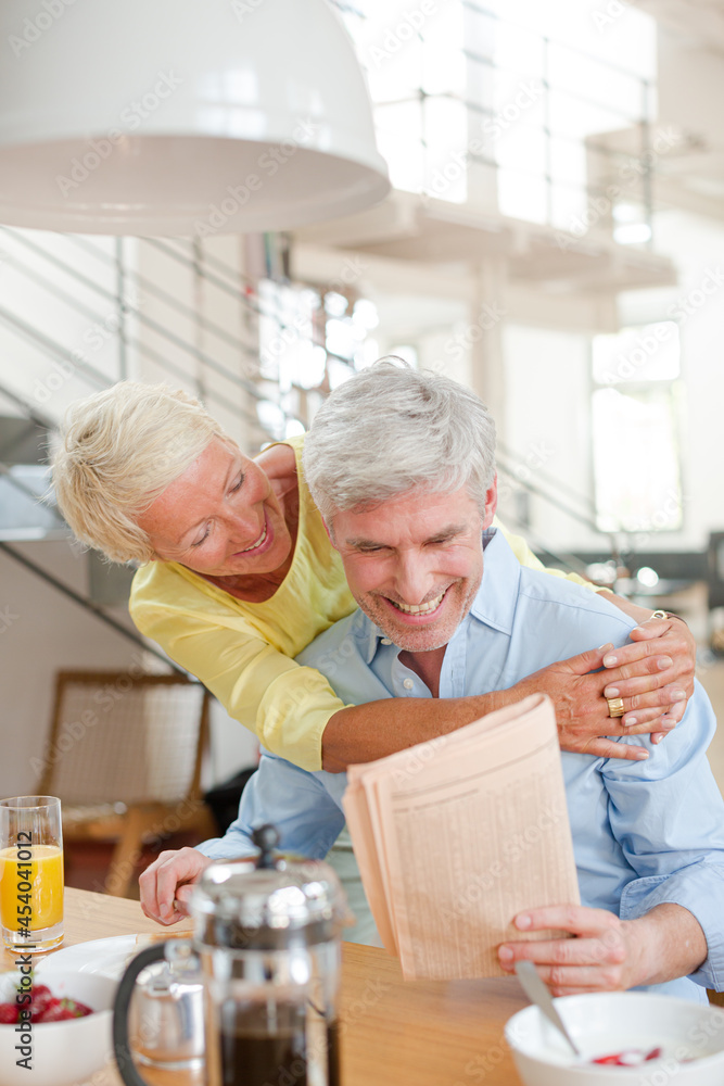 Older couple hugging with coffee cup Older couple hugging with coffee cup