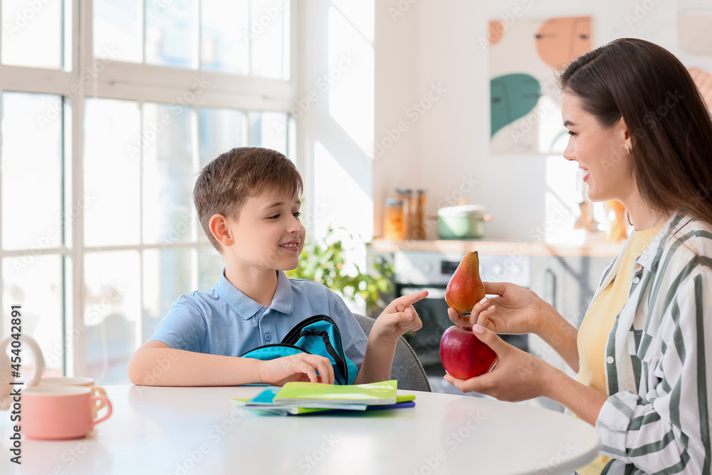 Mother getting her little boy ready for school Mother getting her little boy ready for school