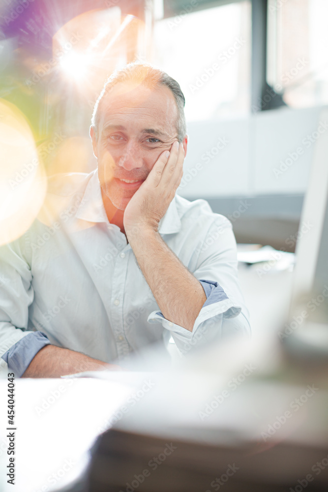 Businessman reading paperwork at home office desk Businessman reading paperwork at home office desk