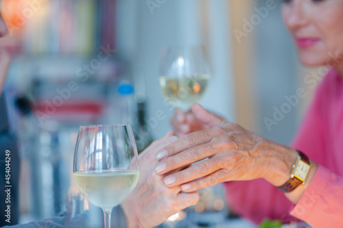 Close up of romantic older couple holding hands