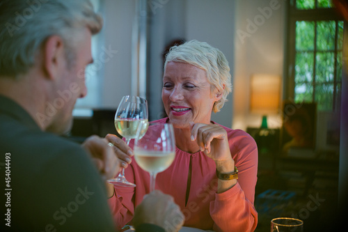 Older romantic couple drinking white wine