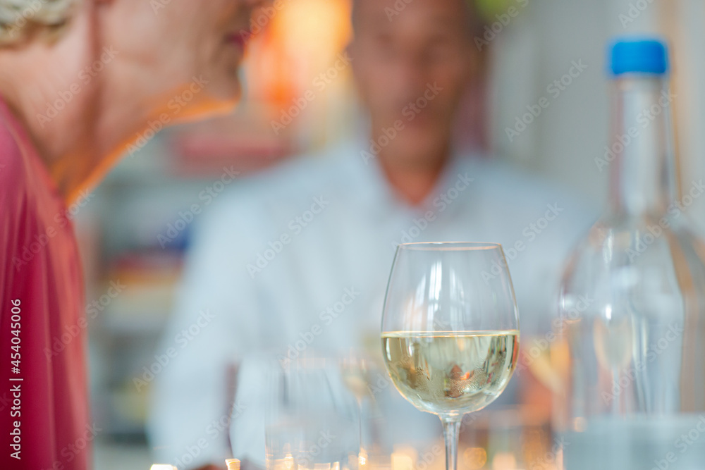 Older romantic couple drinking white wine