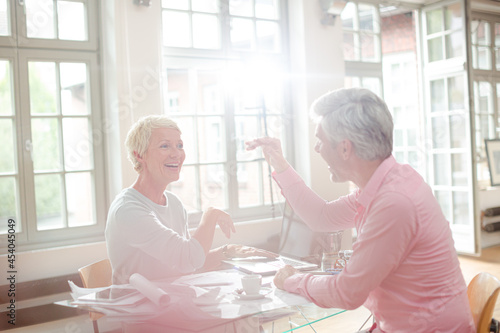 Business people high fiving at home office desk