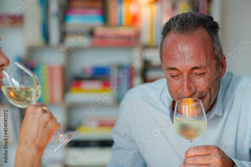 Older friends drinking white wine
