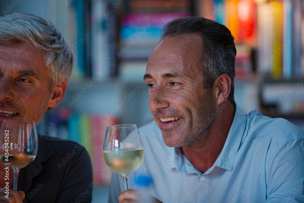 Older friends tasting white wine Older friends tasting white wine
