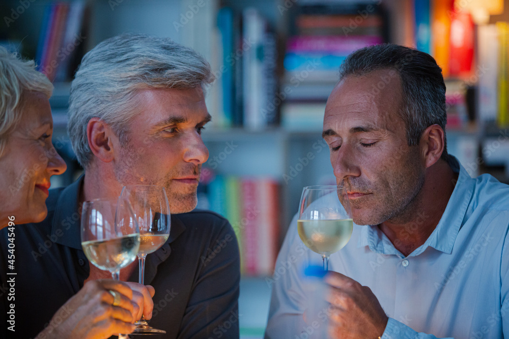Older friends tasting white wine Older friends tasting white wine