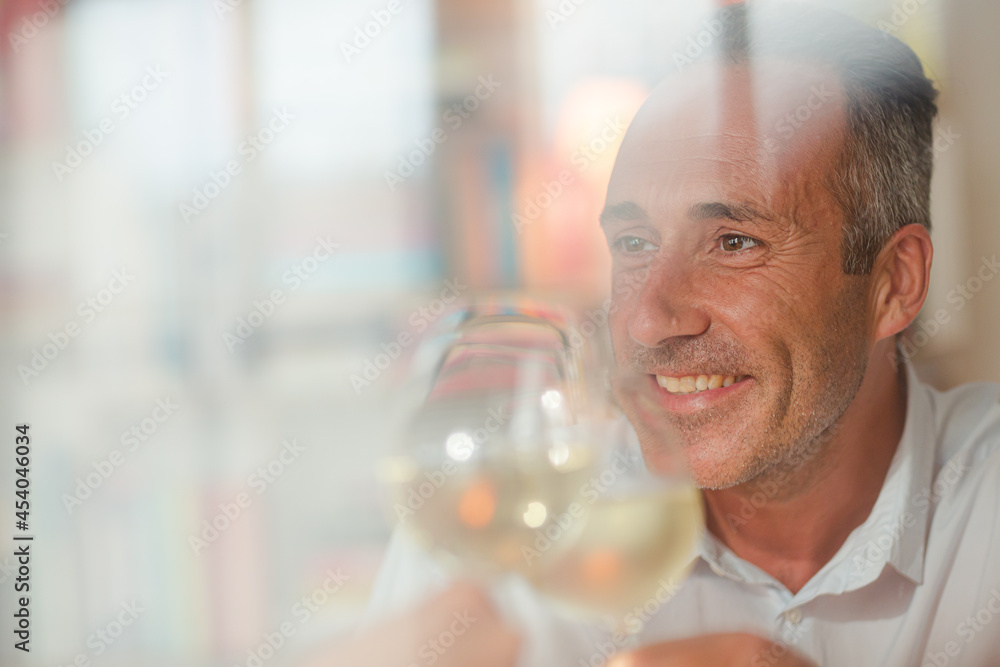 Older man drinking white wine at dinner Older man drinking white wine at dinner