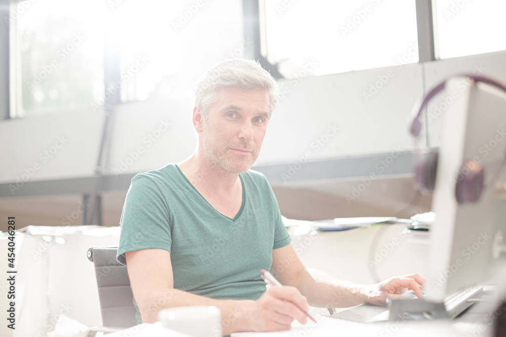 Smiling older man sitting at desk