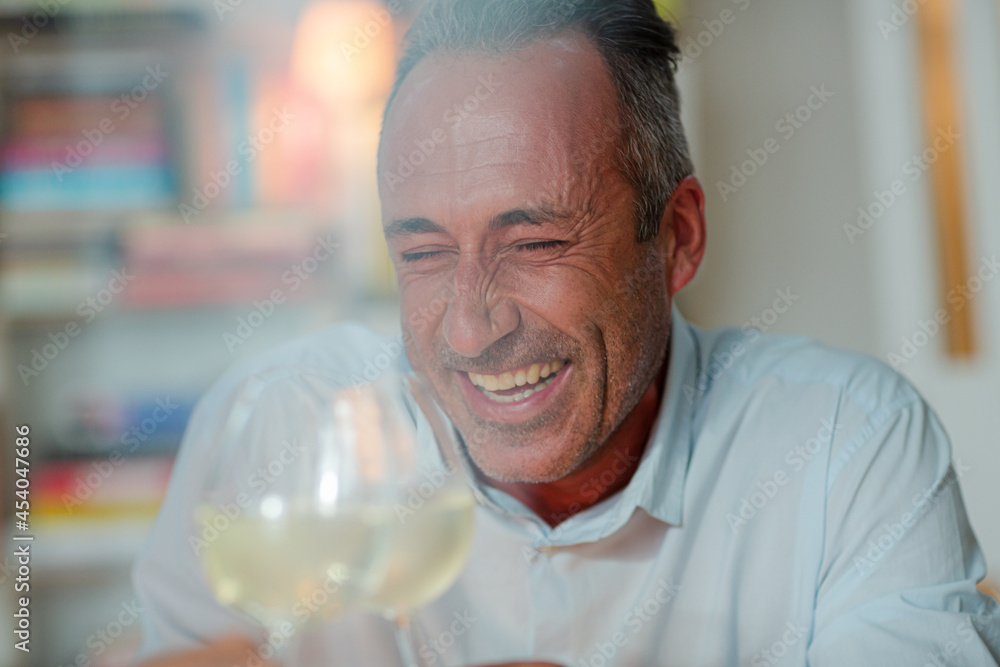 Older man drinking white wine Older man drinking white wine