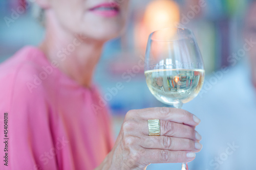Older woman smelling white wine