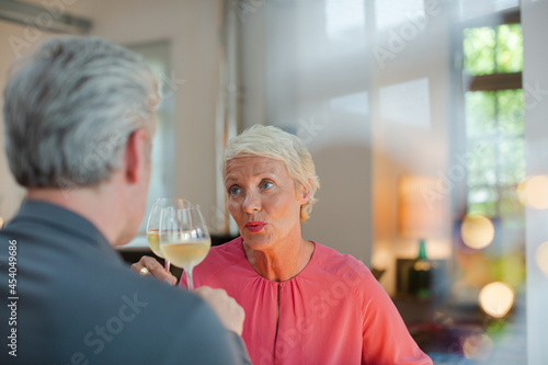 Older romantic couple drinking white wine