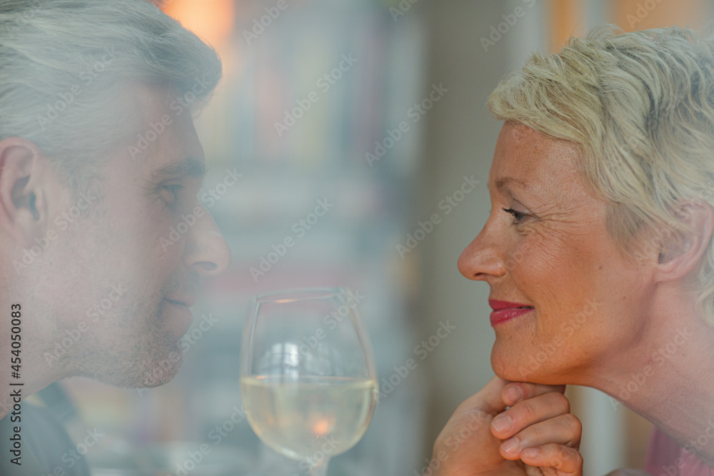 Older romantic couple drinking white wine Older romantic couple drinking white wine
