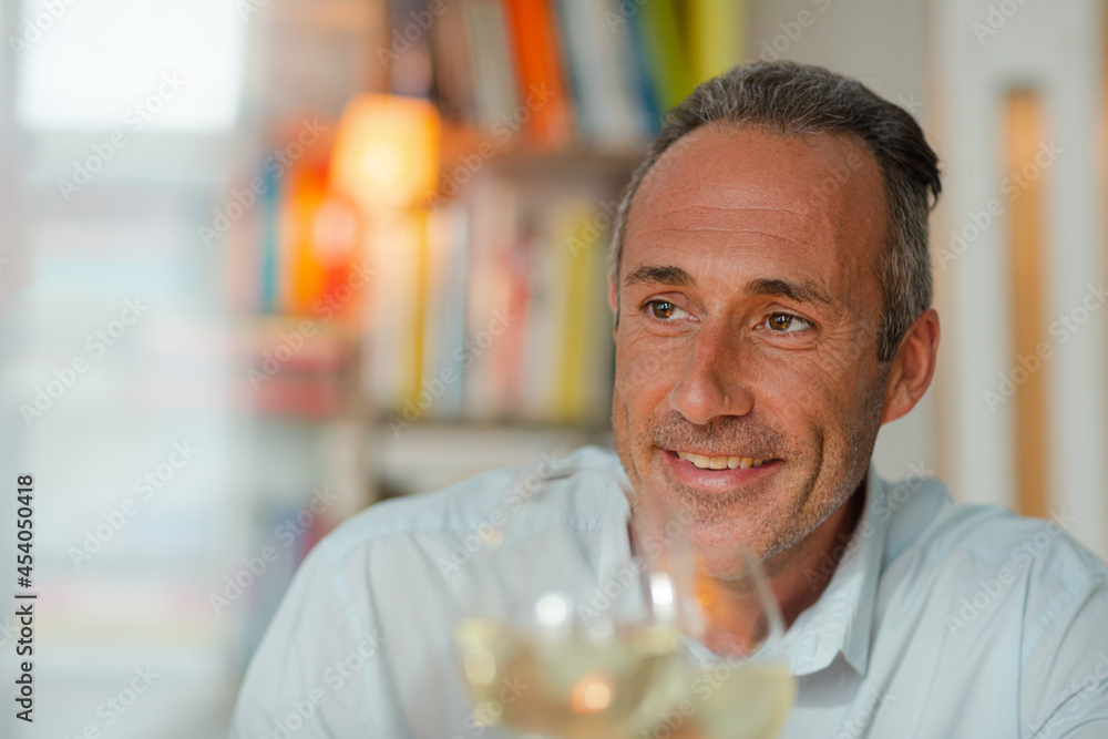 Older man drinking white wine at dinner Older man drinking white wine at dinner