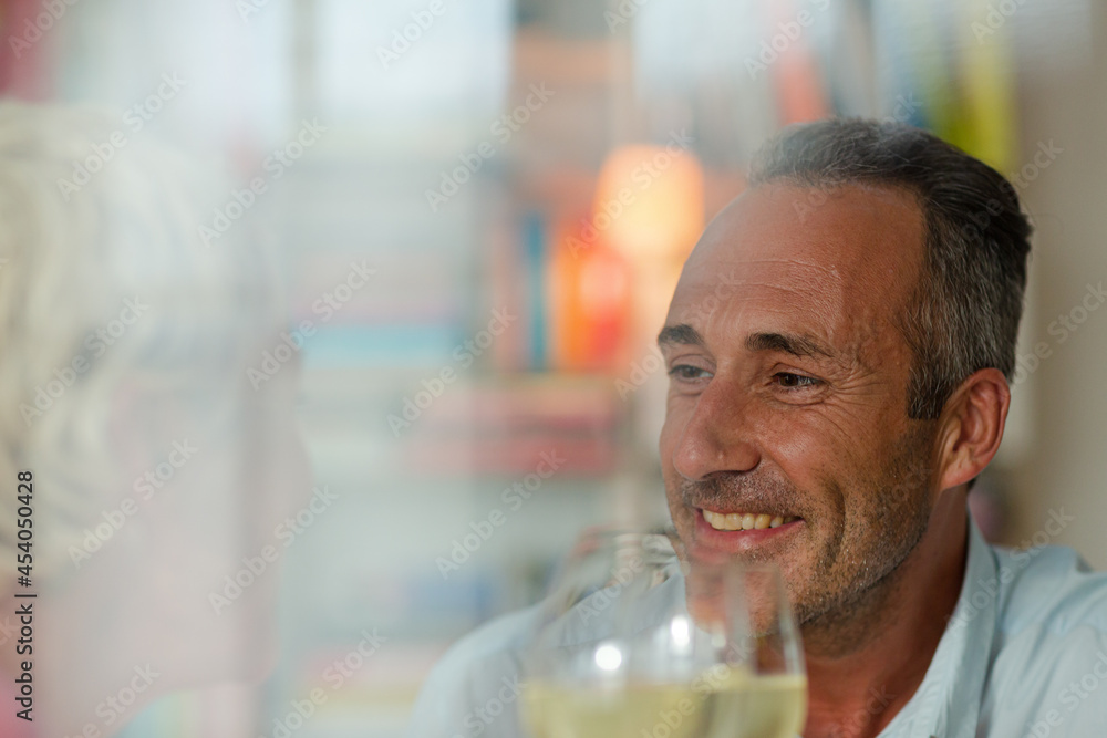 Older man drinking white wine at dinner Older man drinking white wine at dinner