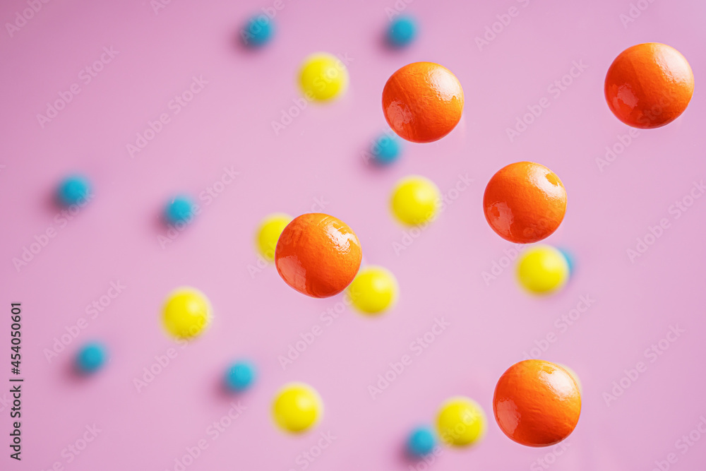 Colorful balls flowing upwards on pink background. .Abstract background with bright balls.