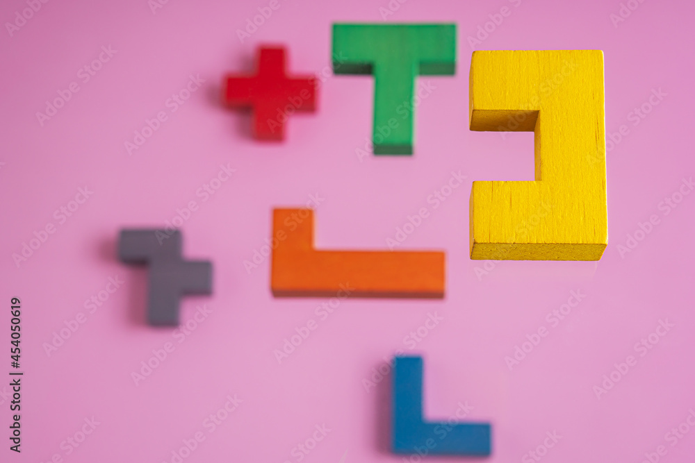 Different colorful shapes wooden blocks on pink background, 3D. Concept of creative, logical thinking. Different colorful shapes wooden blocks on pink background, 3D. Concept of creative, logical thinking.
