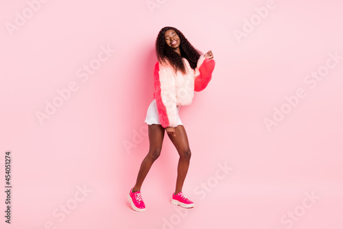 Full size portrait of pretty positive dark skin lady closed eyes have good mood partying isolated pink color background