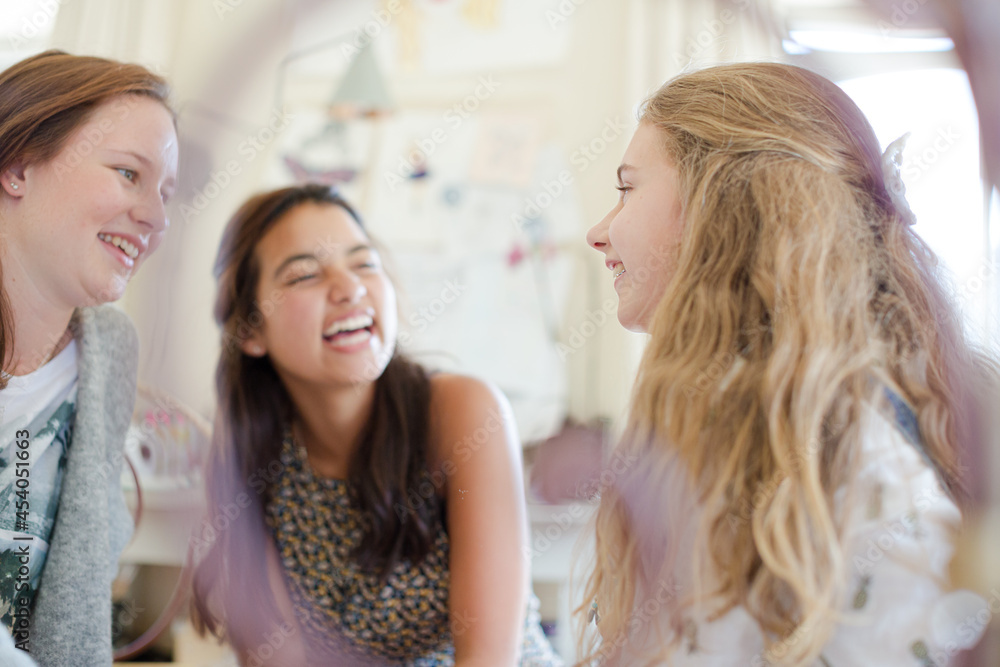 Three teenage girls playing on bed in bedroom Three teenage girls playing on bed in bedroom
