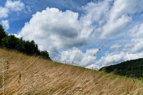 Clouds over the Ochotnica Gorna vilage hills during summer day photo