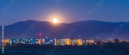 Fototapeta Naklejka Na Ścianę i Meble -  Bystrzyca Klodzka by night, moonrise against the Sudety mountain peaks.