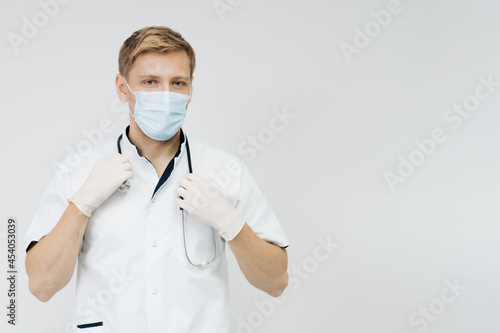 Doctor portrait wearing gloves  Medical Mask and Stethoscope. Medical Concept on white background
