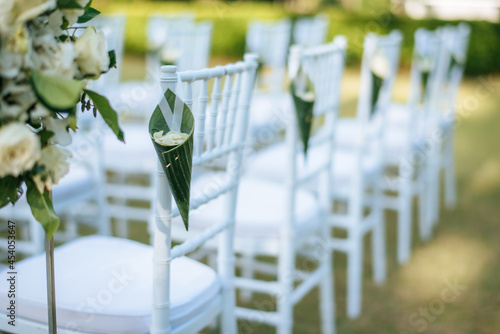 Wedding ceremony. Arch,Chair decorated with flowers on the lawn.