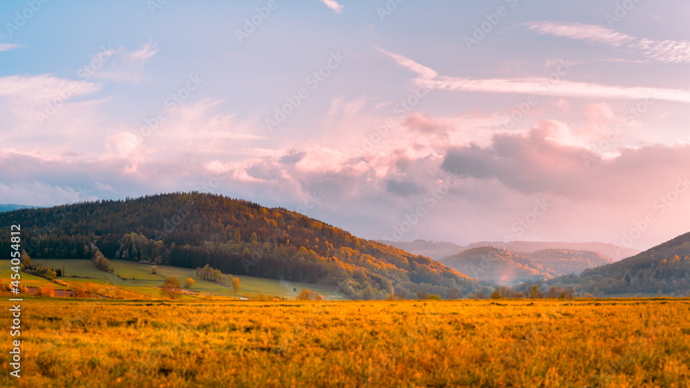 Bystrzyca Klodzka, mountain landscape, a view of the Bystrzyckie Mountains and farmland before sunset.