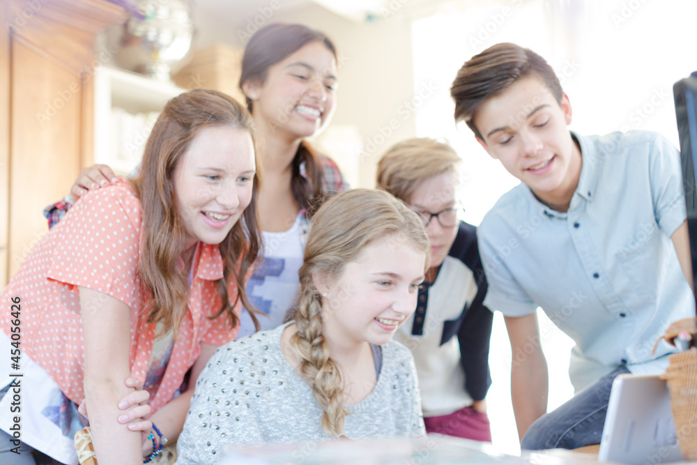 Group of teenagers waving while communicating via internet Group of teenagers waving while communicating via internet