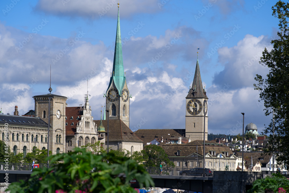 Protestant churches St. Peter and Fraumünster (Womens's Minster) at the old town of Zurich at a beautiful cloudy summer day. Photo taken August 27th, 2021, Zurich, Switzerland.