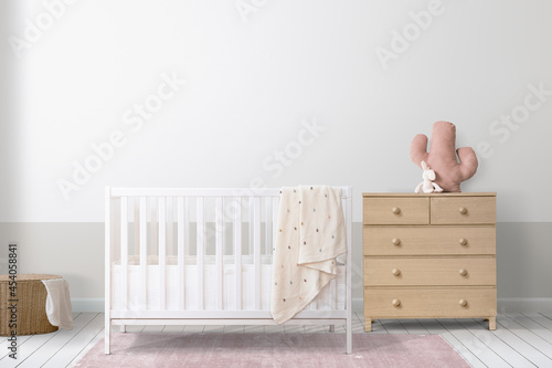 White crib in a minimal nursery room photo